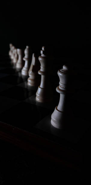 Chess board with white queen, king followed by others